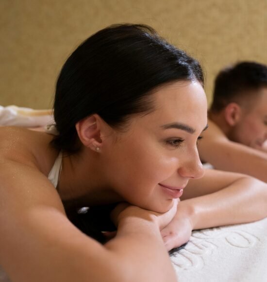 Couple enjoying a relaxing massage in a tranquil spa setting, promoting wellness.